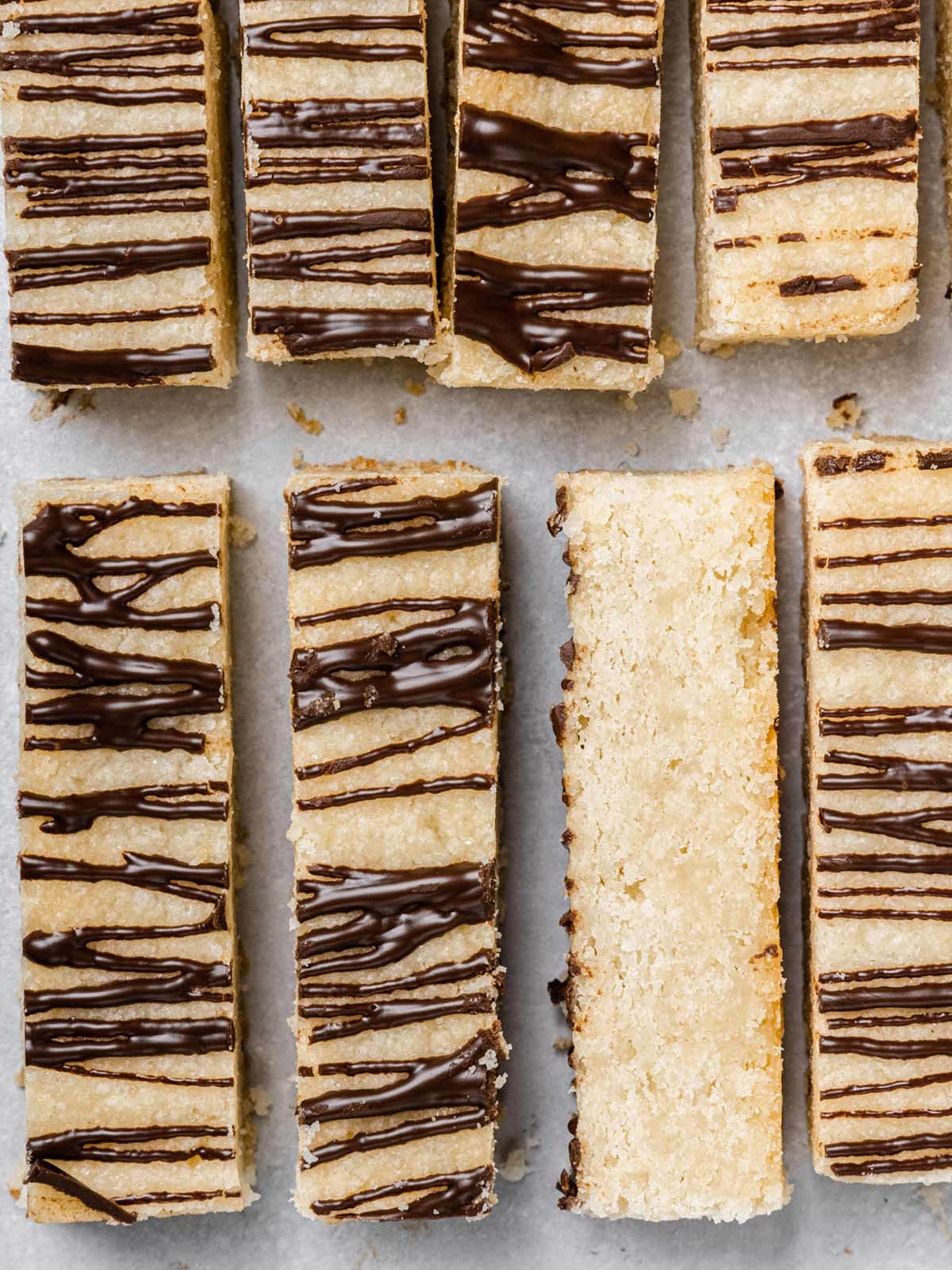 Rows of shortbread bar cookies with drizzled chocolate