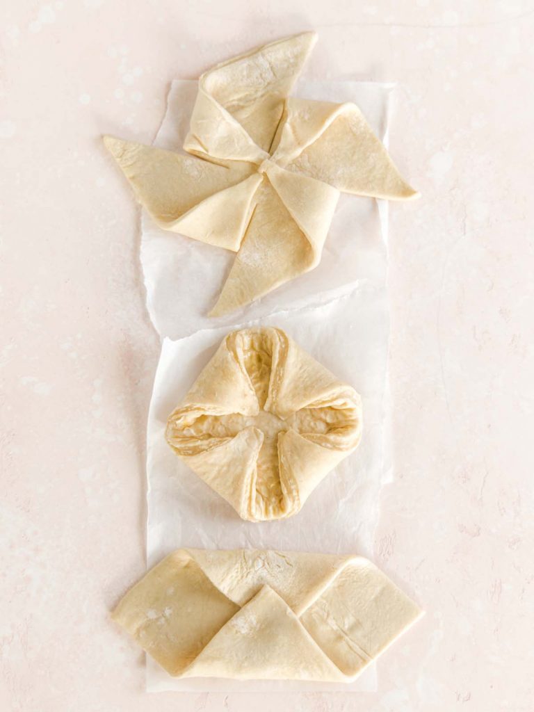 Three shapes of danishes on parchment paper.