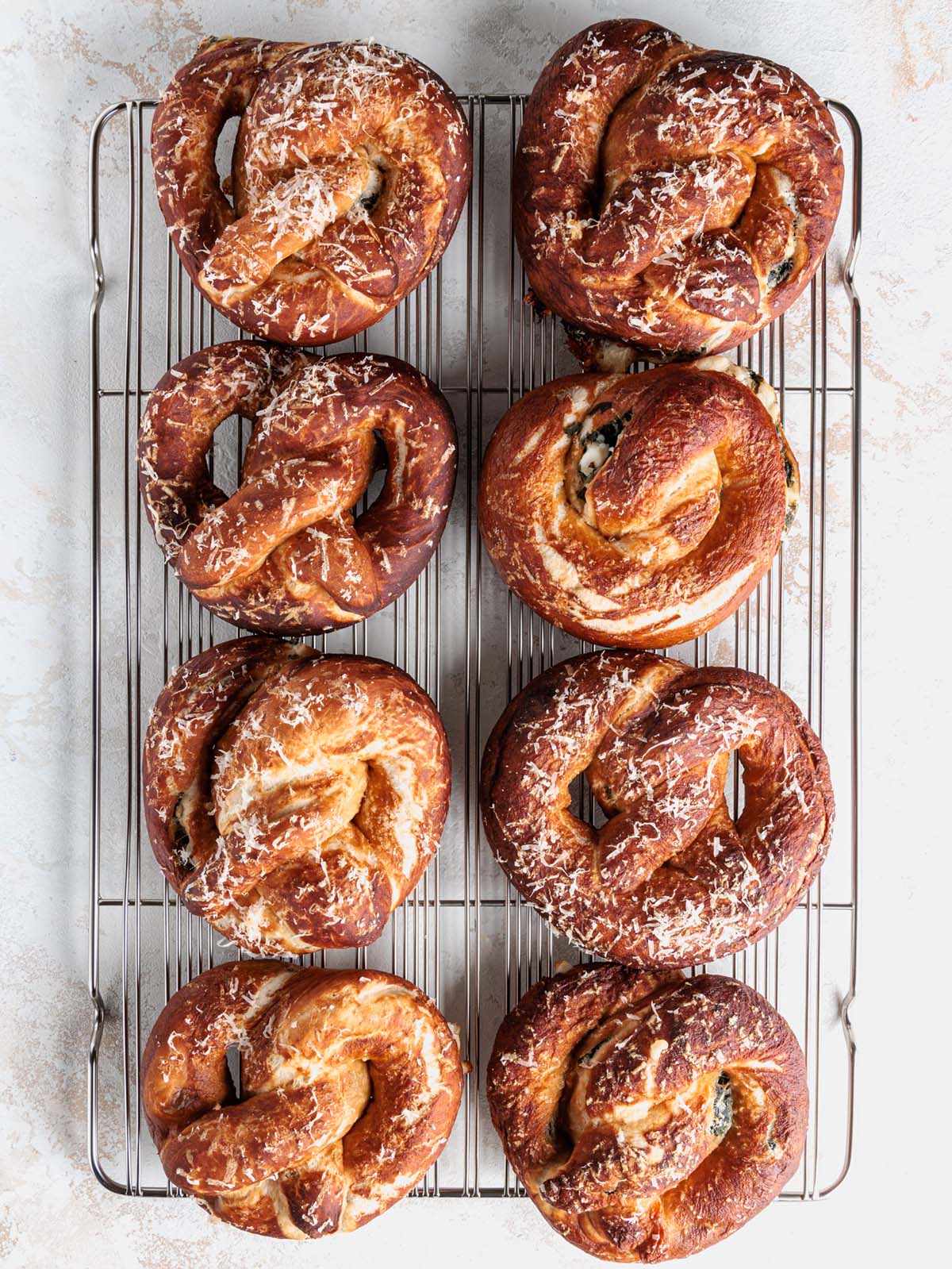 8 soft pretzels overhead on cooling rack.