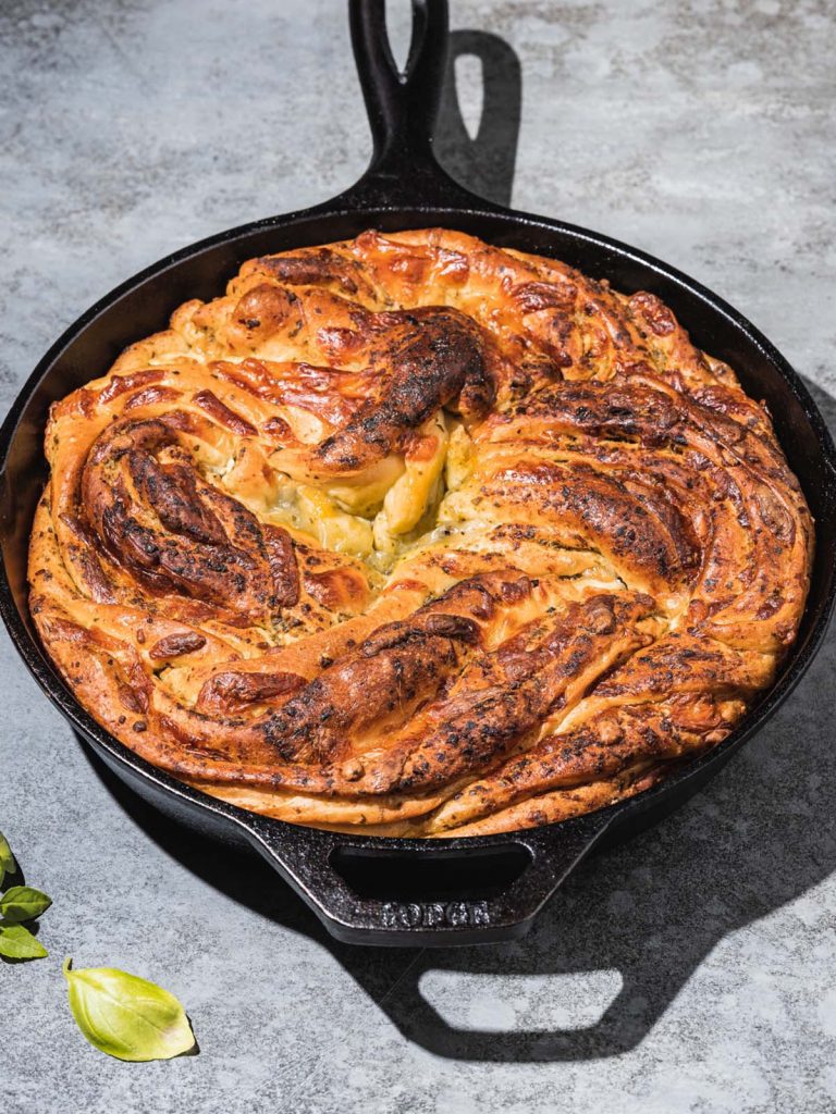 Swirled pesto bread in cast iron skillet.