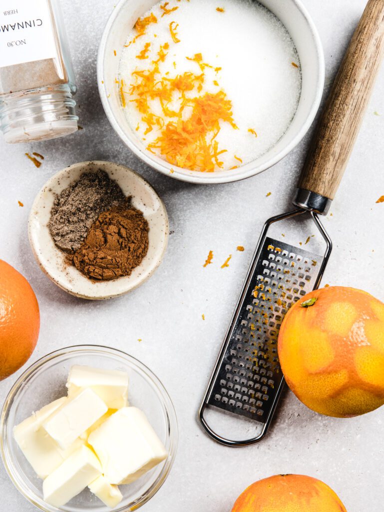 Sugar bowl with zested orange, butter and cinnamon dish.