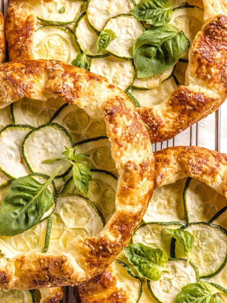 Close up of three galettes with fresh basil.