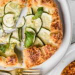 Close up of sliced galette with fresh basil.