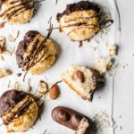 Macaroons on parchment paper with chocolate drizzle.
