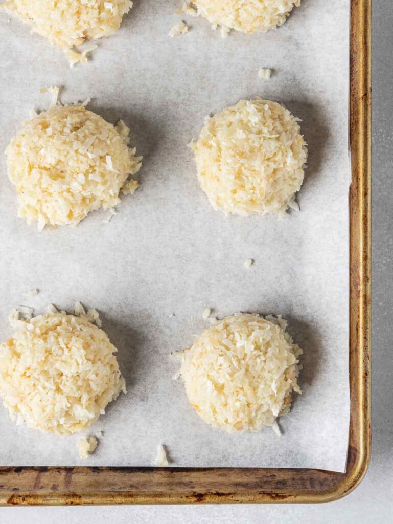 Unbaked macaroons on sheet pan.