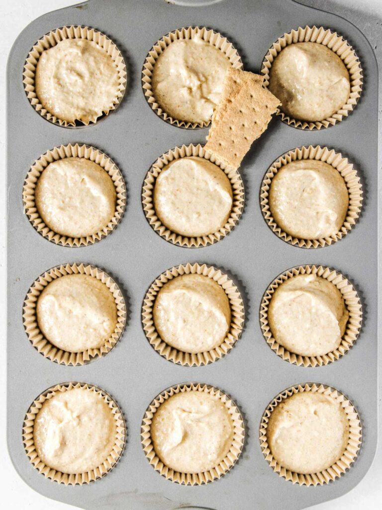 Unbaked cupcake tray with graham crackers.