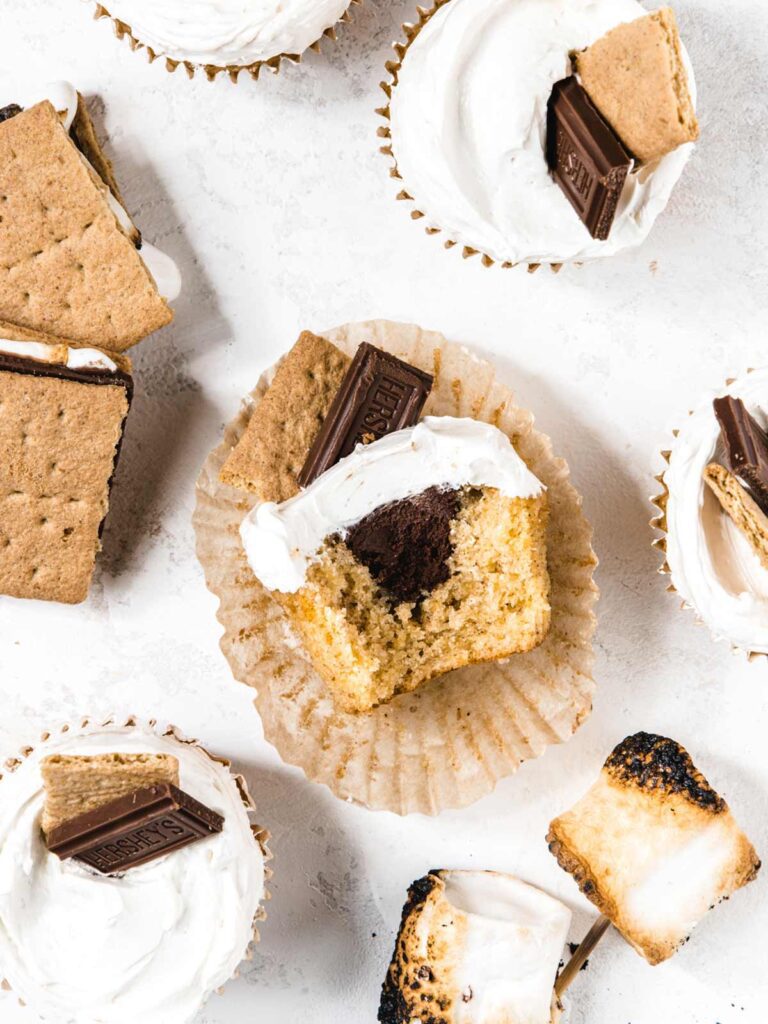 Sliced cupcake with chocolate ganache center with s'mores and toasted marshmallow.