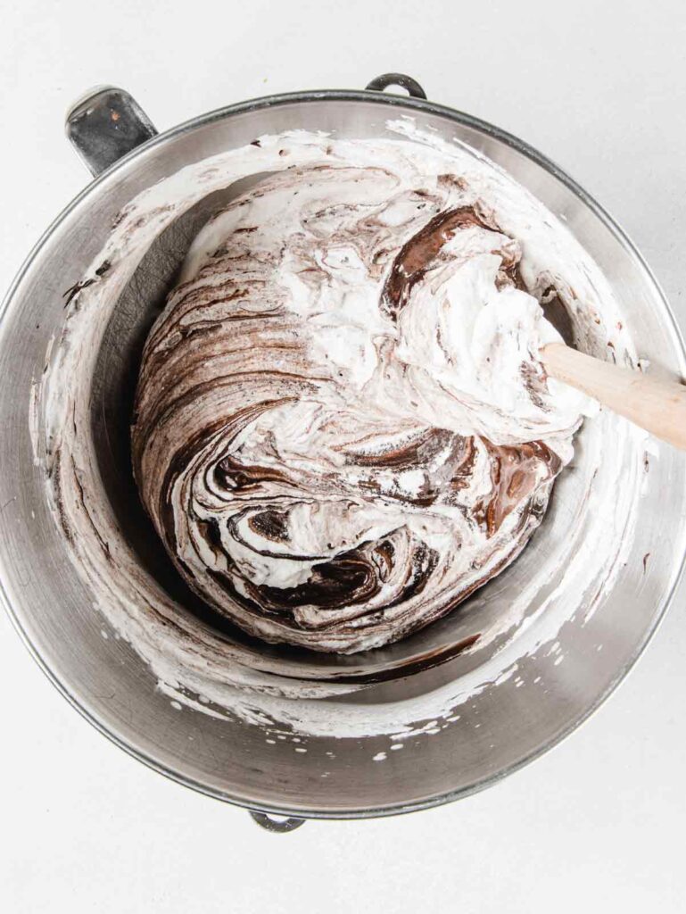 Mixing whipped cream with chocolate.