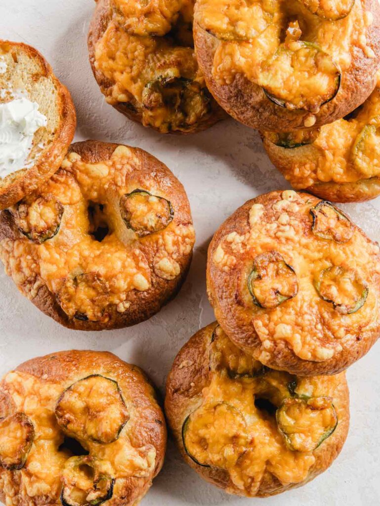 Pile of cheddar bagels with jalapeños.