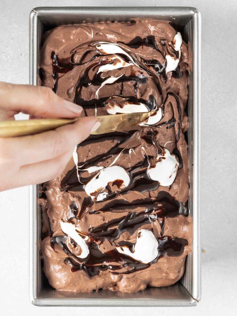 Swirling chocolate and marshmallow in chocolate ice cream.