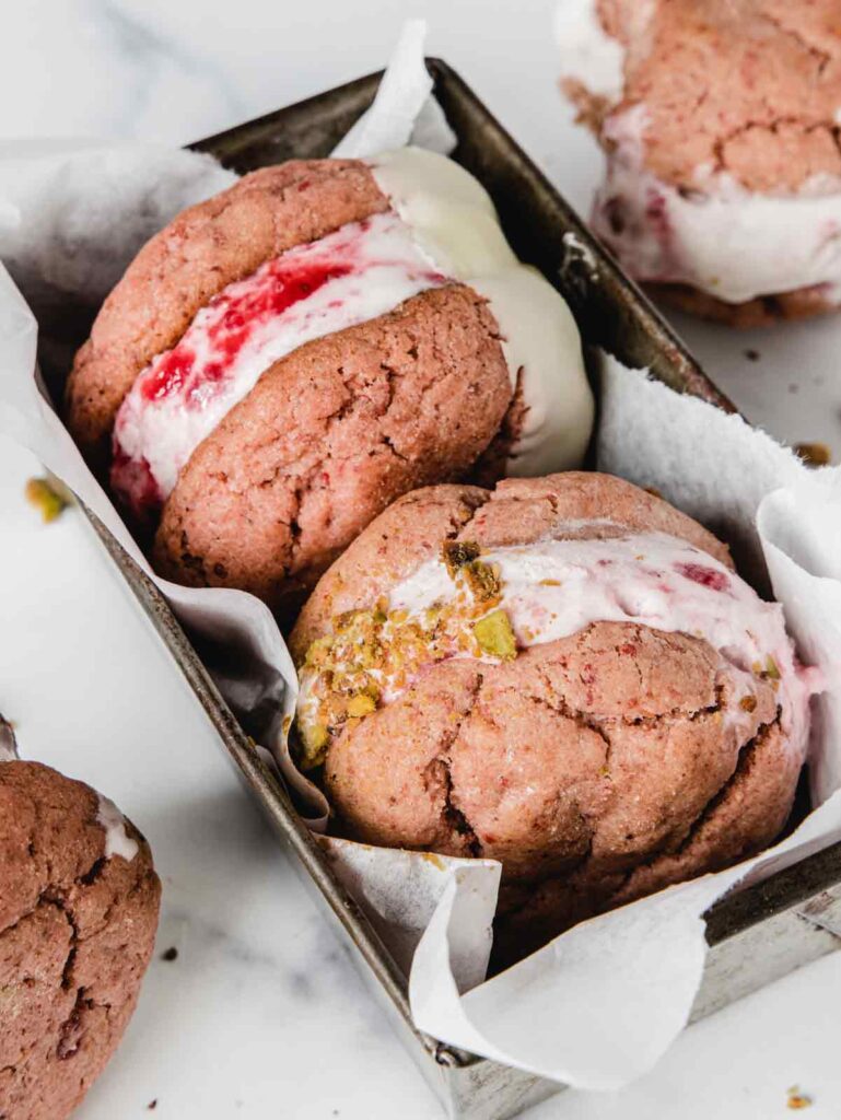 Two ice cream sandwiches in pan with paper liner.