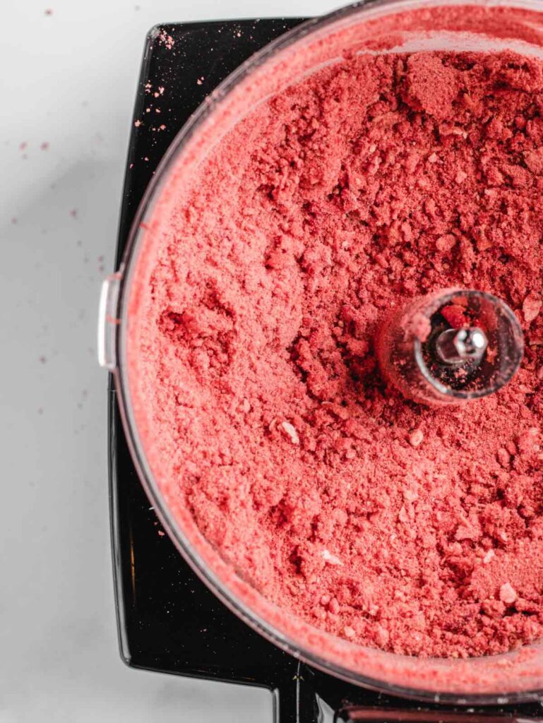 Freeze-dried crumbled strawberries in food processor.