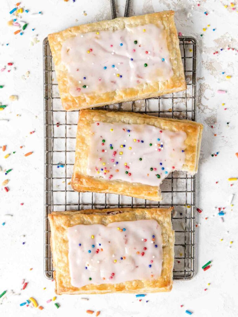 3 pop tarts on cooling rack with bite removed.