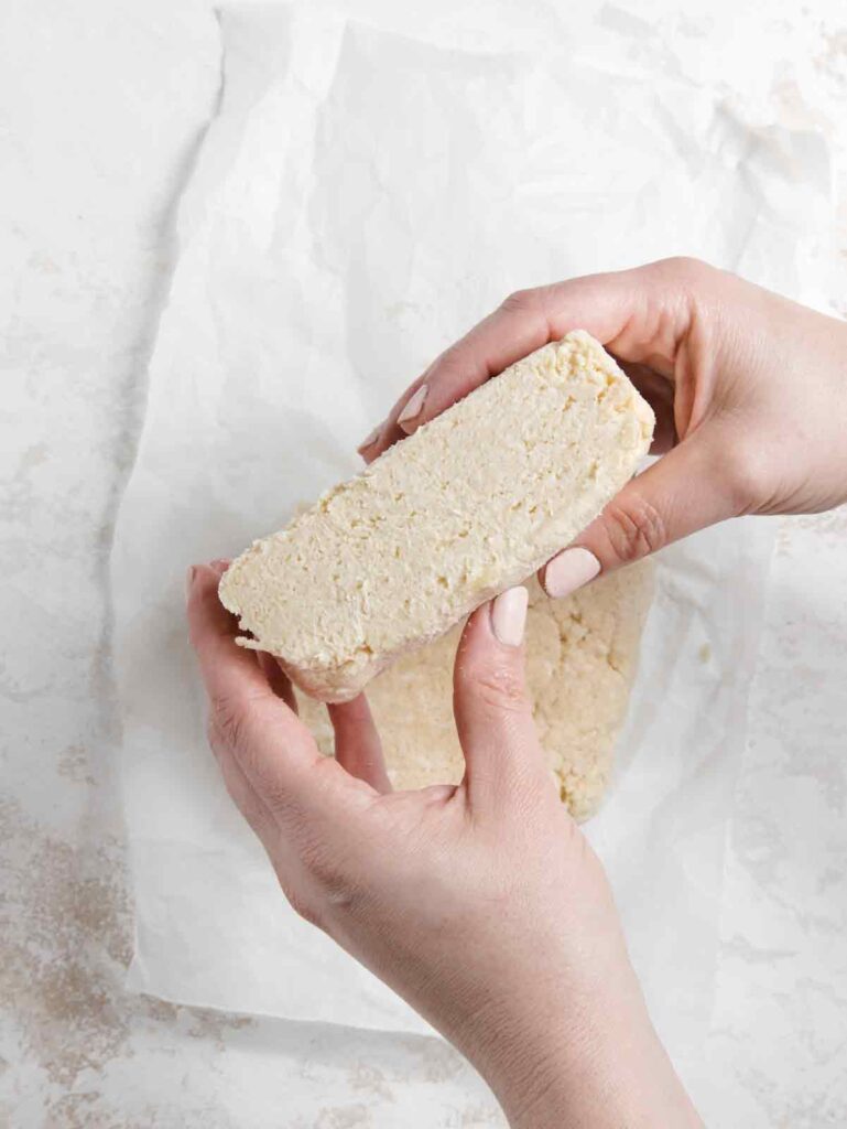 Holding sliced dough.