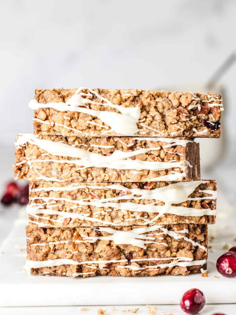 Stack of sliced loaf cake with white chocolate drizzle.