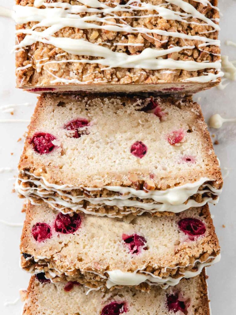 Close up of sliced cranberry bread on marble.