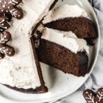 Close up of sliced cake on plate with 2 slices on side.