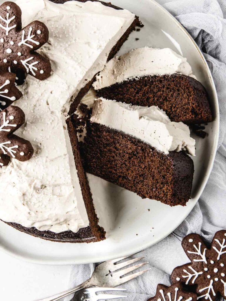 Close up of sliced cake on plate with 2 slices on side.