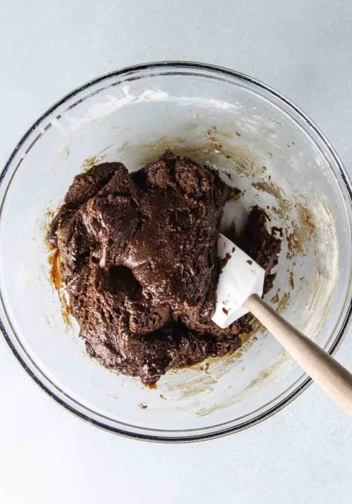 Cake batter in process of being made in bowl.