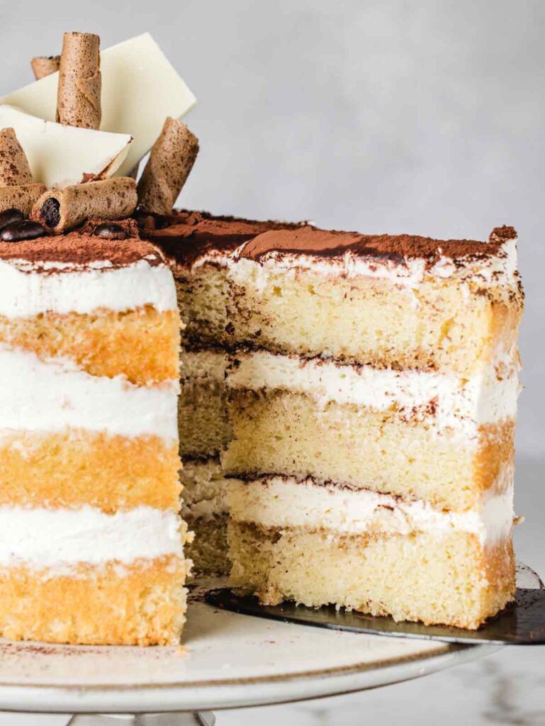 Removing slice of cake from cake stand.