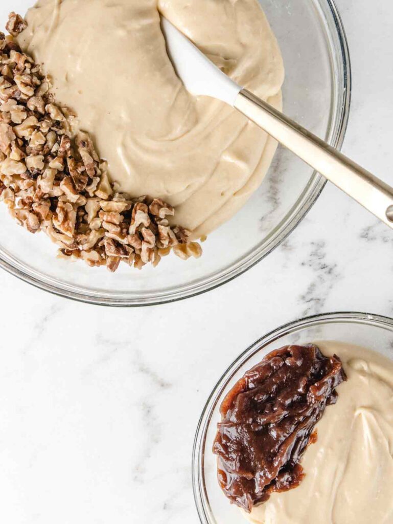 One bowls of cake batter with walnut and apple butter mix-ins.