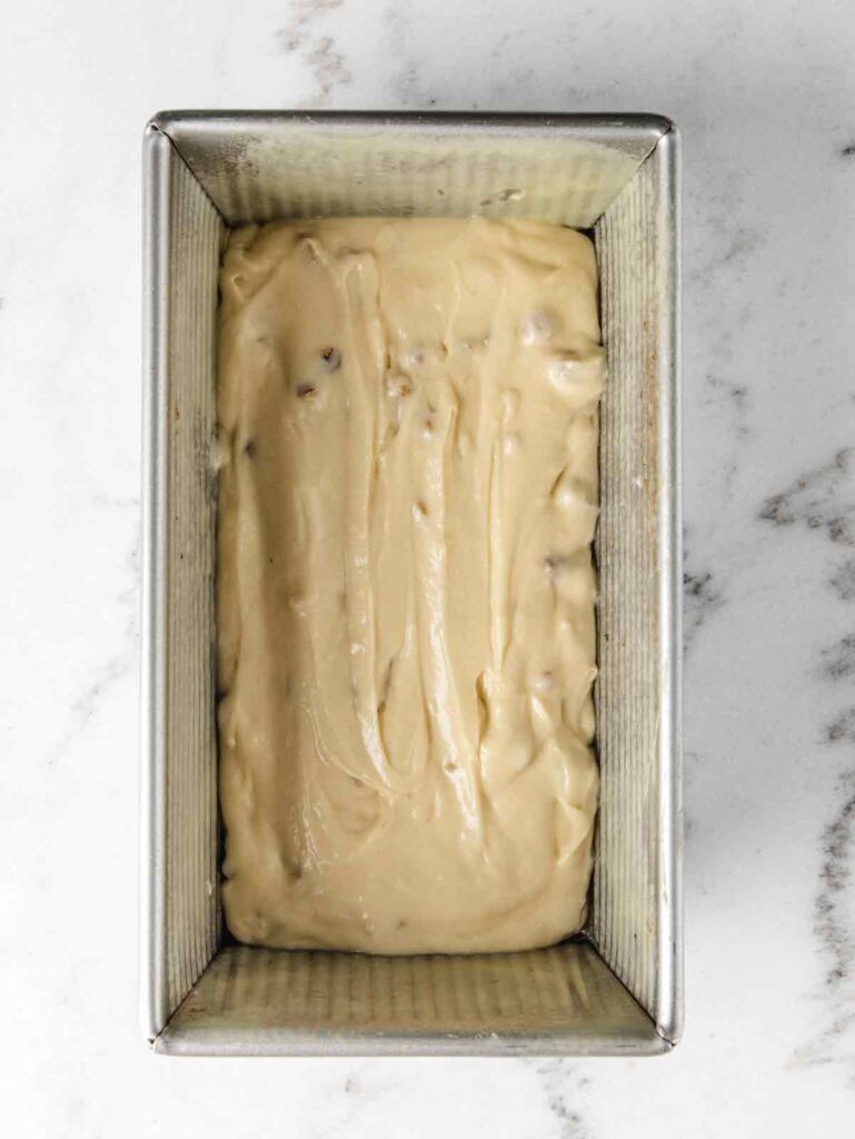 Loaf pan with cake batter.