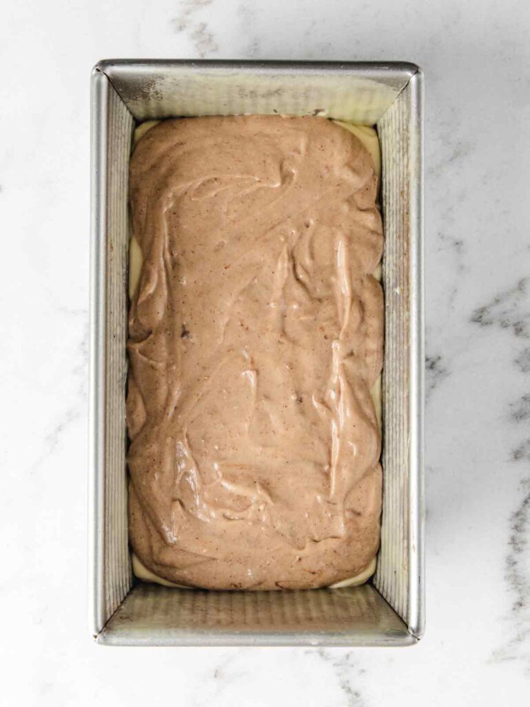 Loaf pan with cake batter.