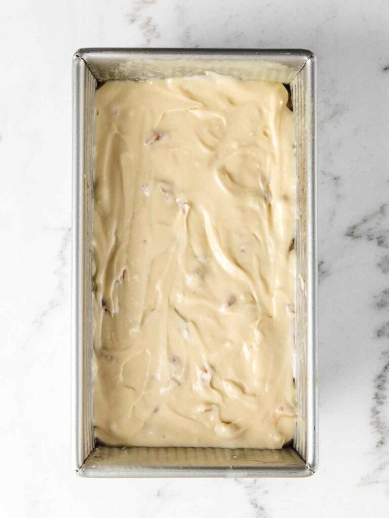 Loaf pan with cake batter.