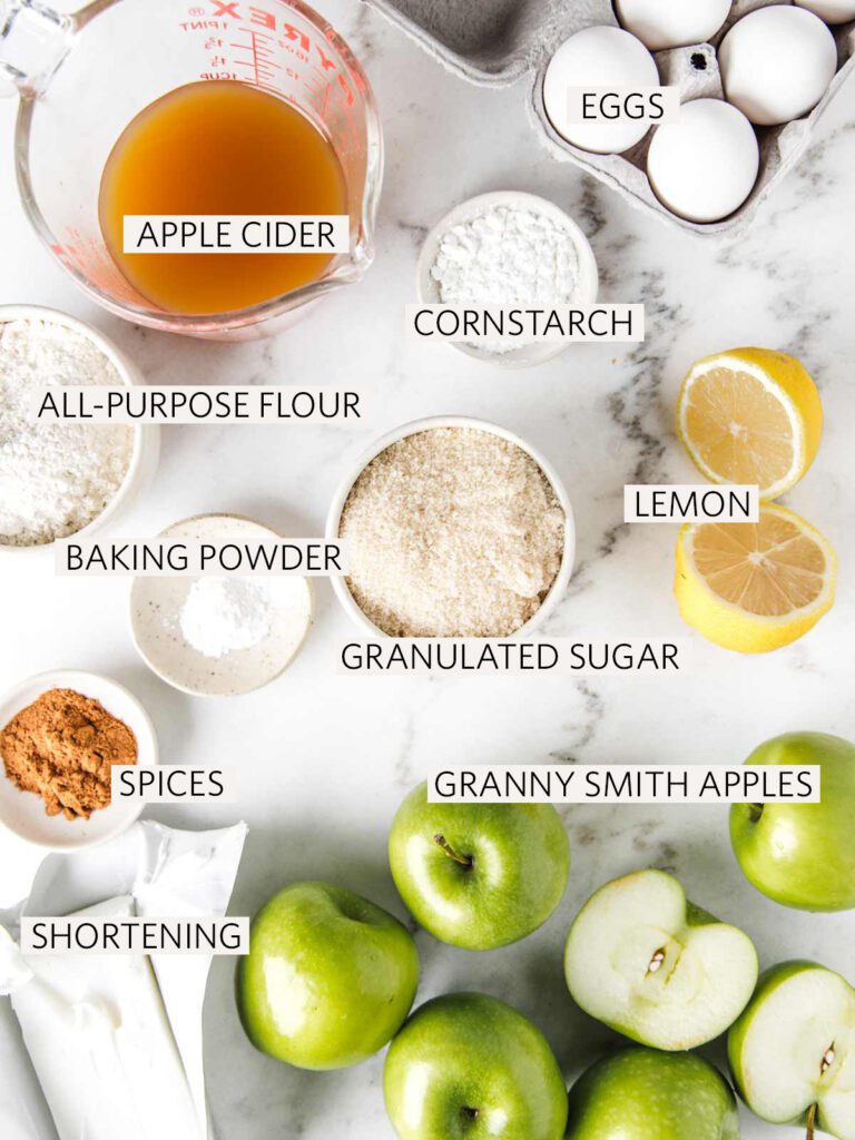 Ingredients for apple pie on board with labels.