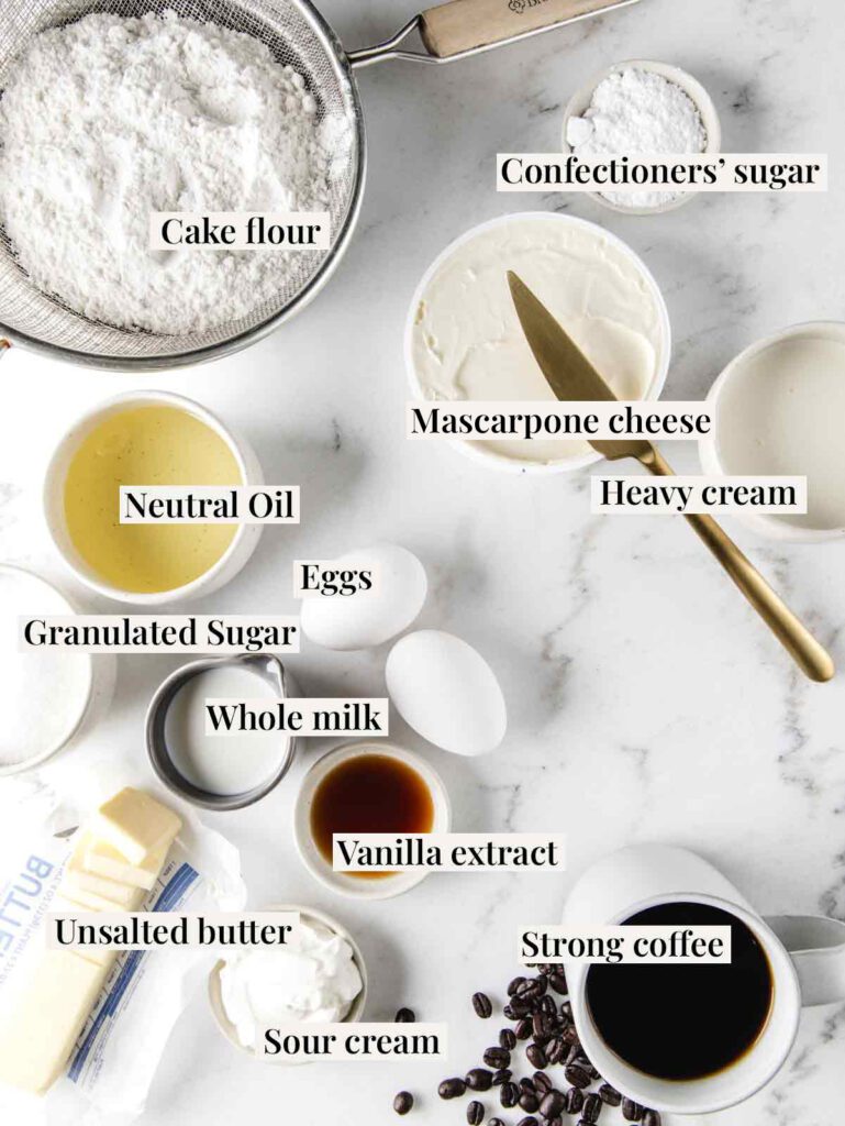 Ingredients for tiramisu cake on table with labels.