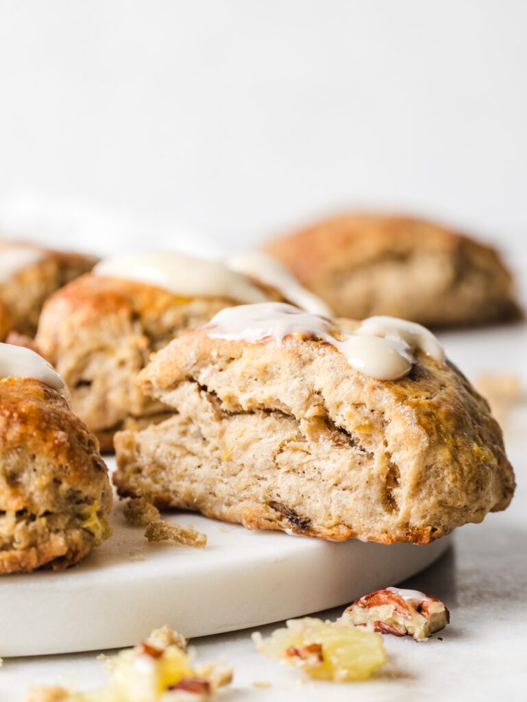 Side view of scones on cutting board with glaze on top.