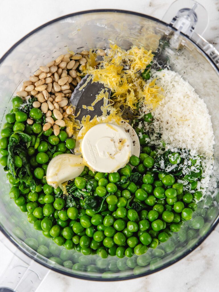 Food processor bowl with ingredients.