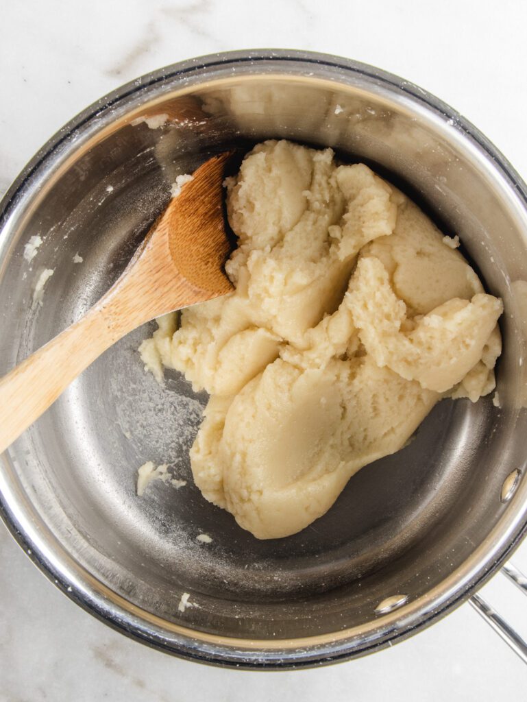 Cooked choux dough in pot.