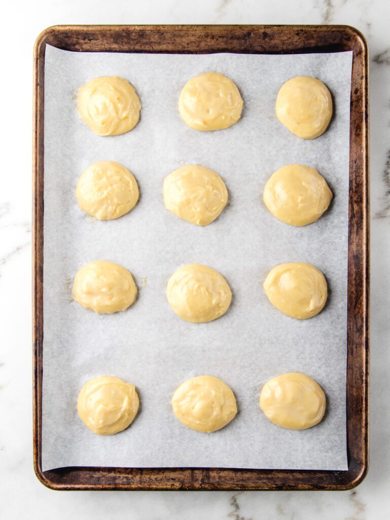 Unbaked choux dough on baking sheet.