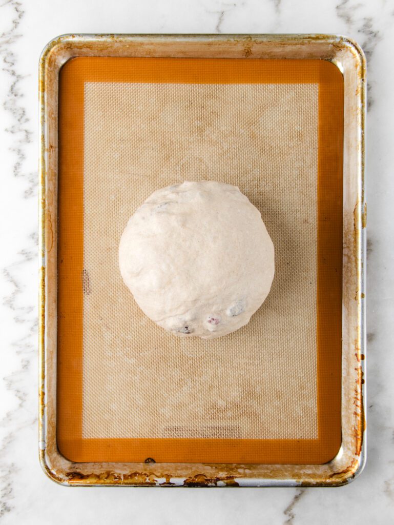 Unrisen bread dough on baking mat.