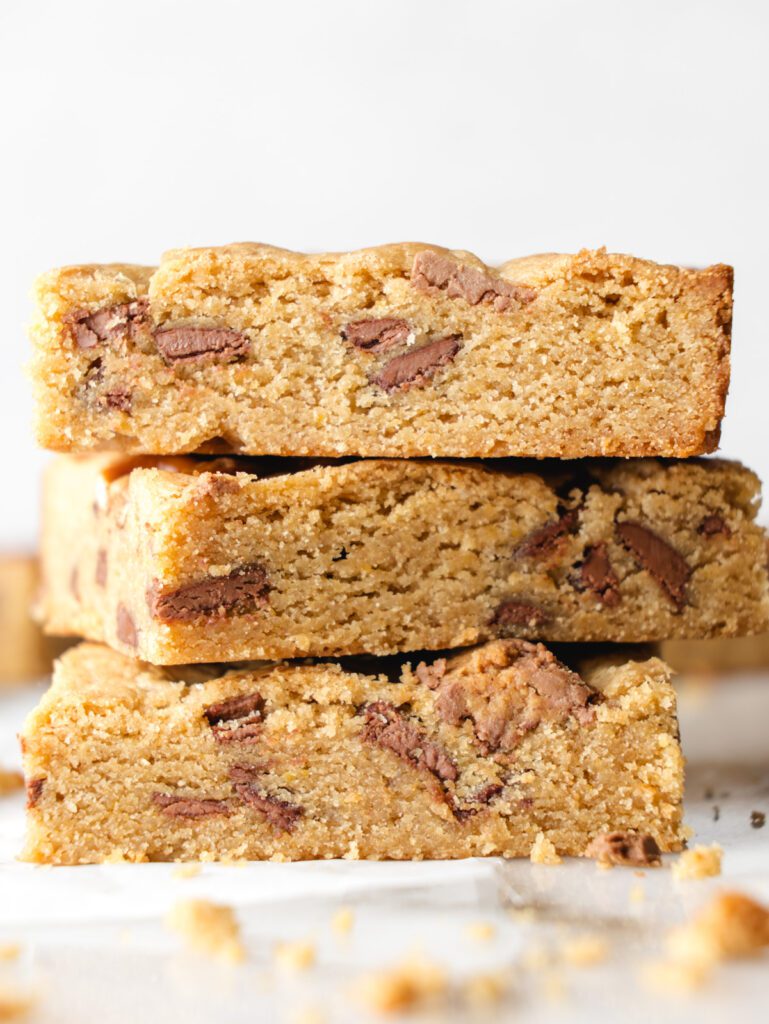 Stack of 3 blondies on parchment paper.
