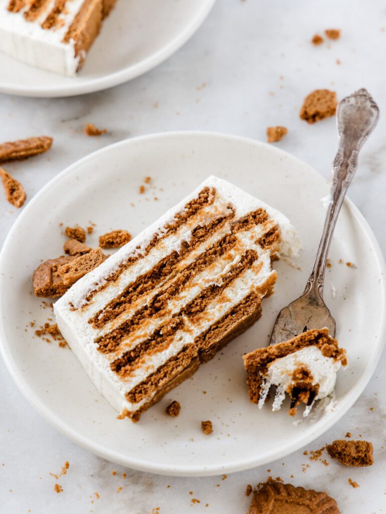 Slice of layered cake on plate with fork.