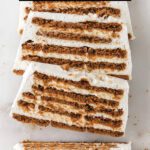 Layered loaf cake sliced on marble.