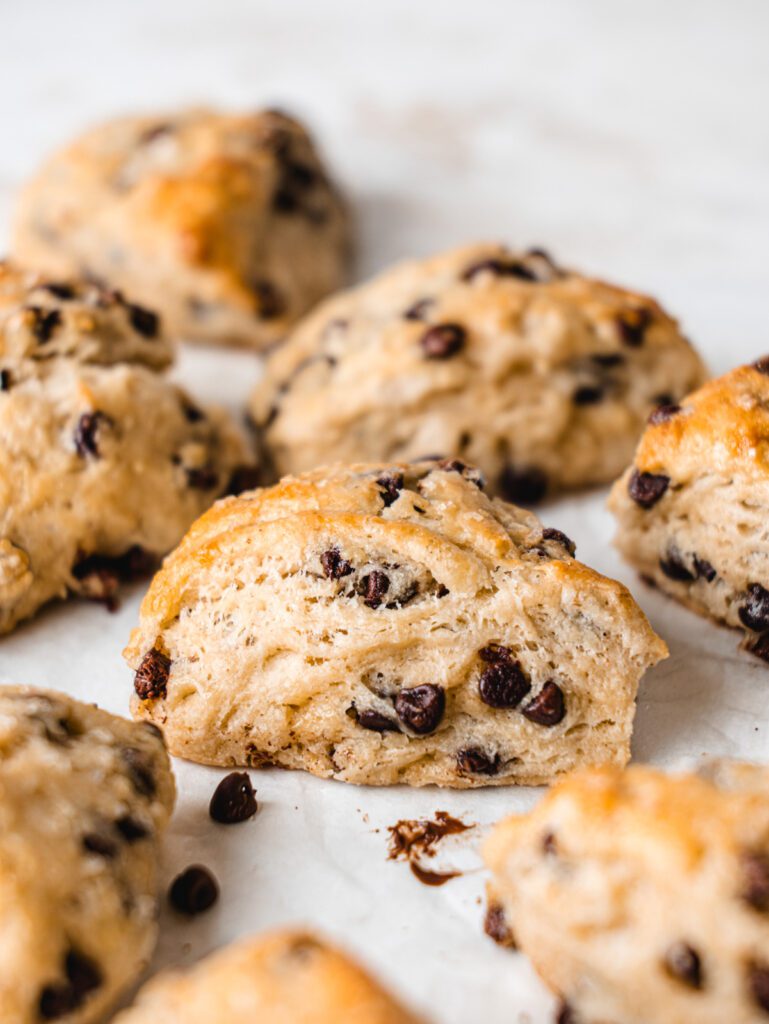 Scones scattered on table with chocolate chips.