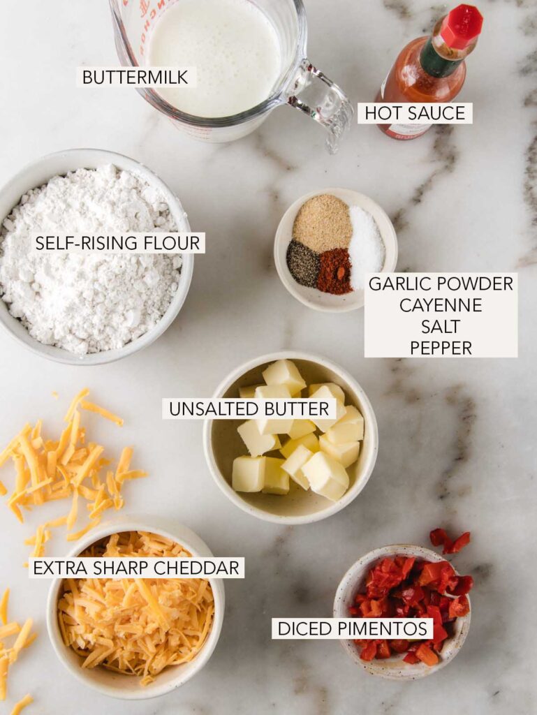 Ingredients of pimento cheese biscuits in bowls with labels.