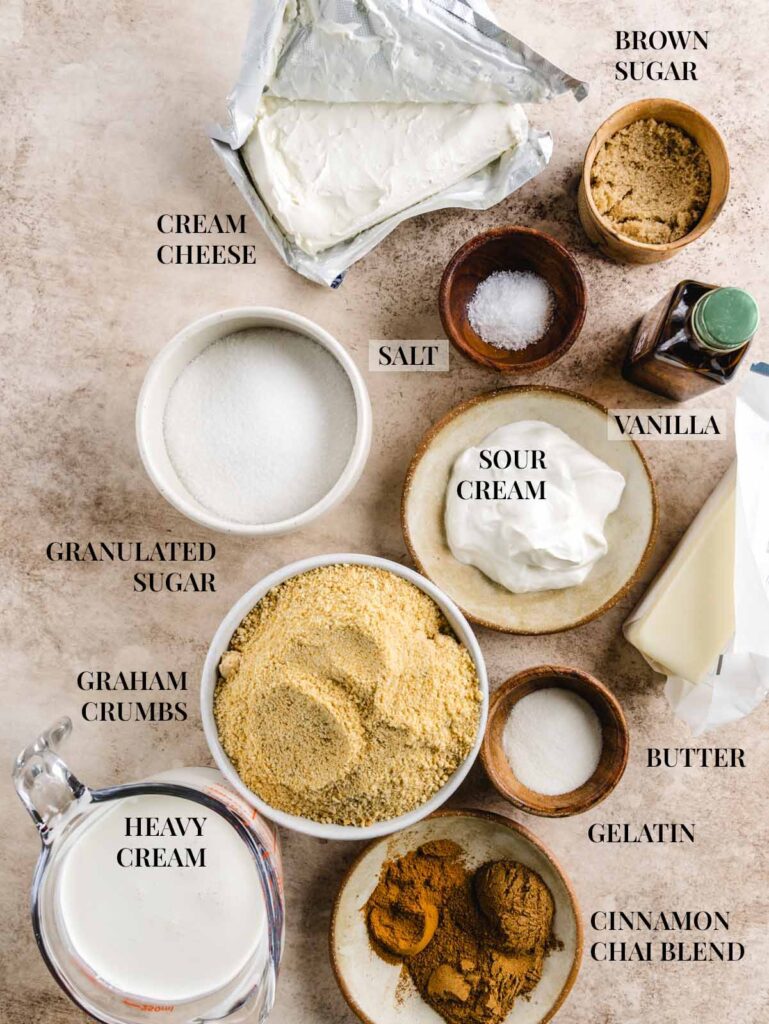 Ingredients for chai cheesecake in bowls with labels.