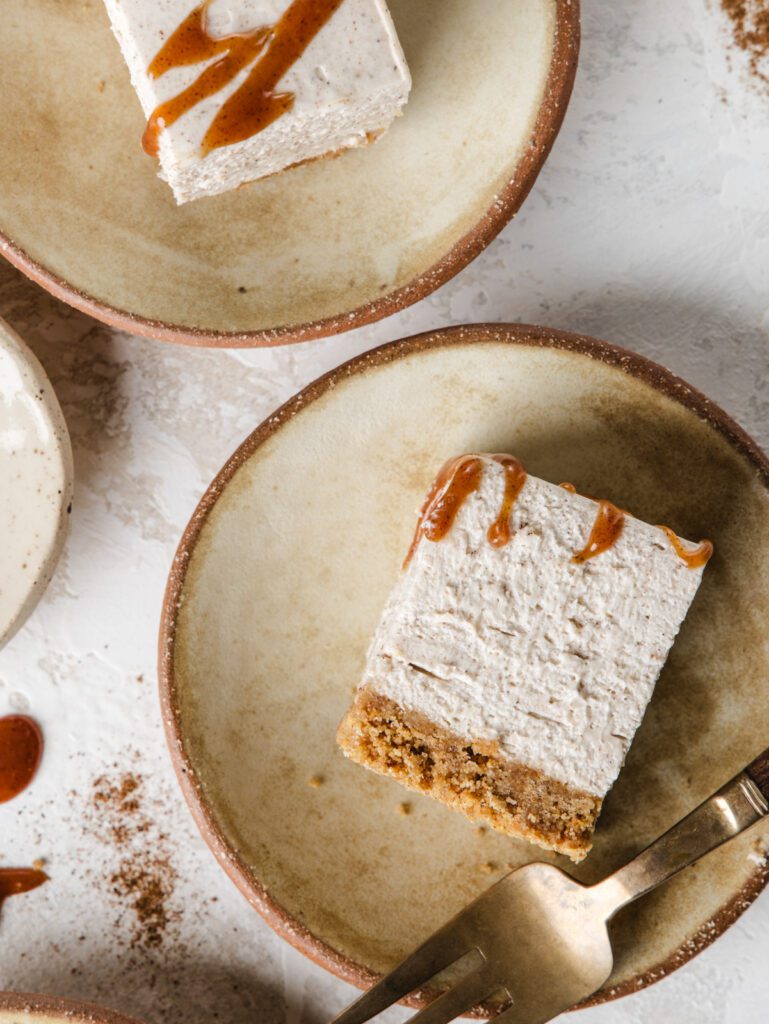 Slices of cheesecake on plates with fork.