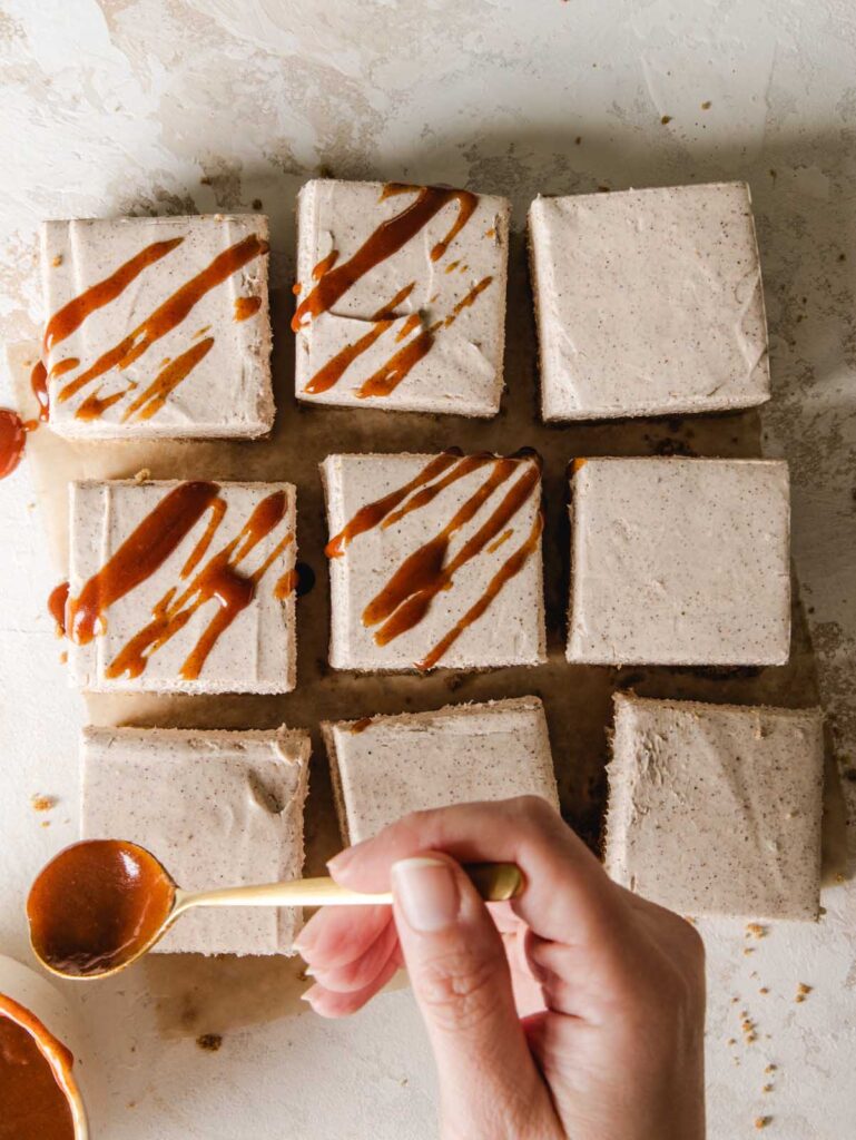 Drizzling caramel on slices of cheesecake.