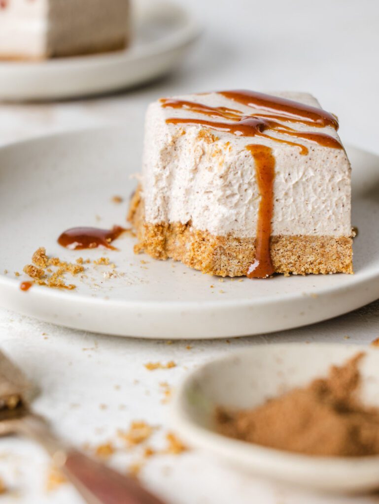 Cheesecake square on plate with bite removed.