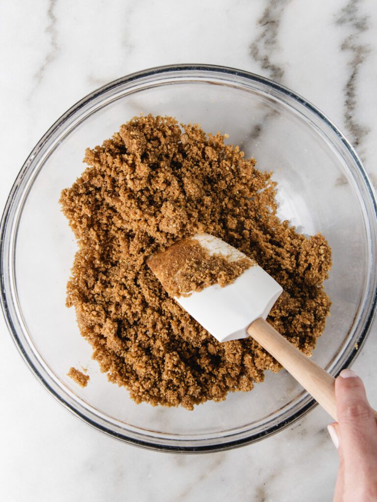 Cookie crumbs in bowl with spatula.