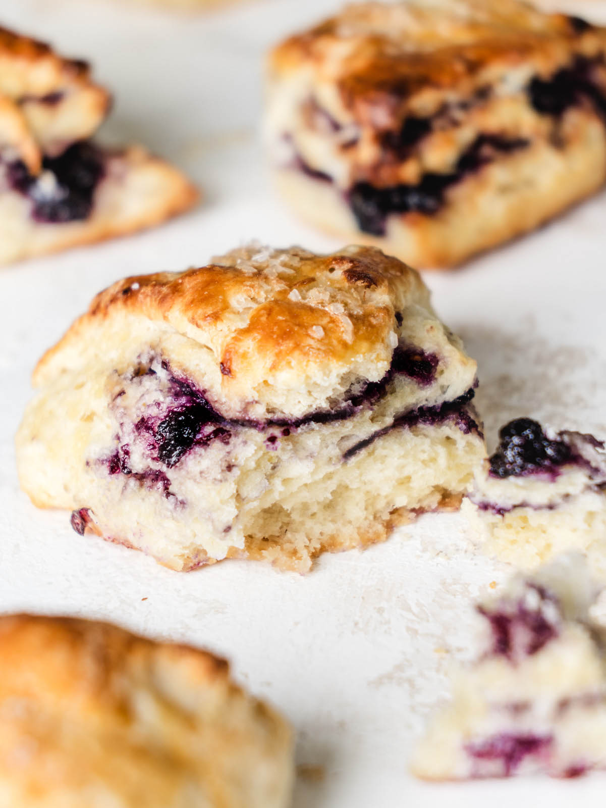 Side of scone broken in half with swirls of jam in the middle.