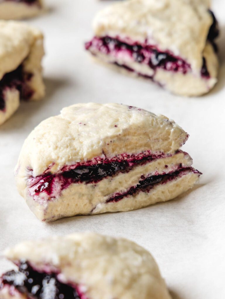 Unbaked scone with layers of jam.